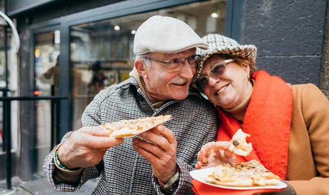 a couple eating pizza