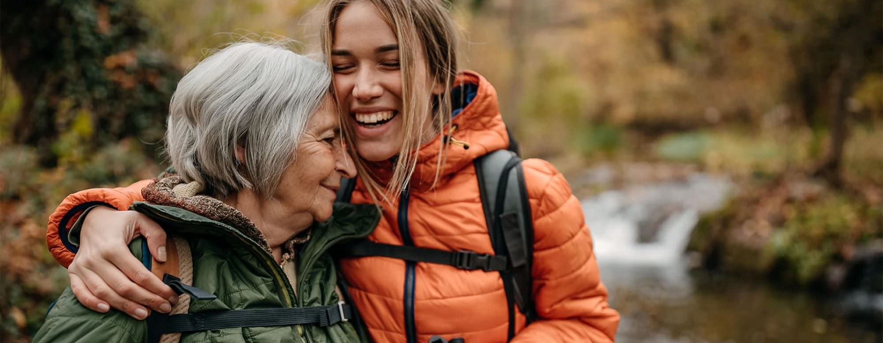 a couple of women smiling while hiking