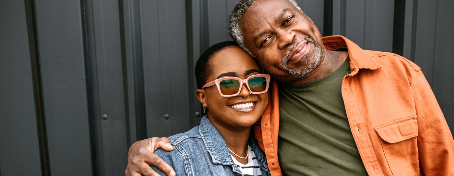 a man and woman smiling while hugging